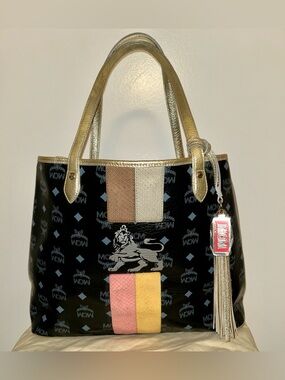 MCM Black Visetos Coated Canvas and Leather Princess Lion Shopper
Tote. A++🔥